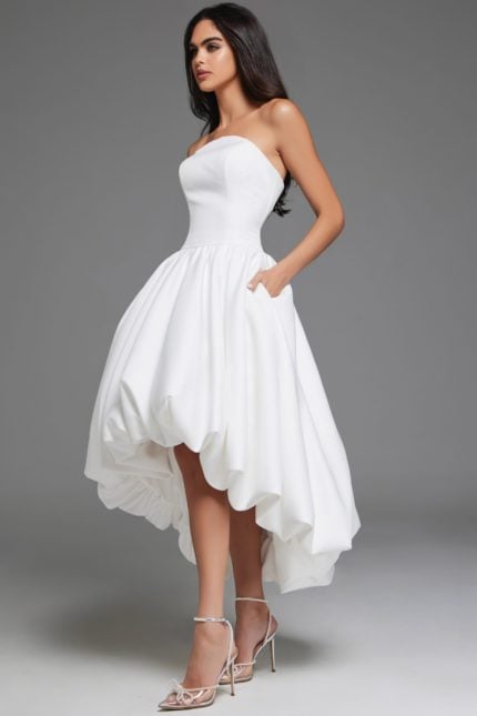 Model wearing Jovani 42345 off-white high-low dress, side view