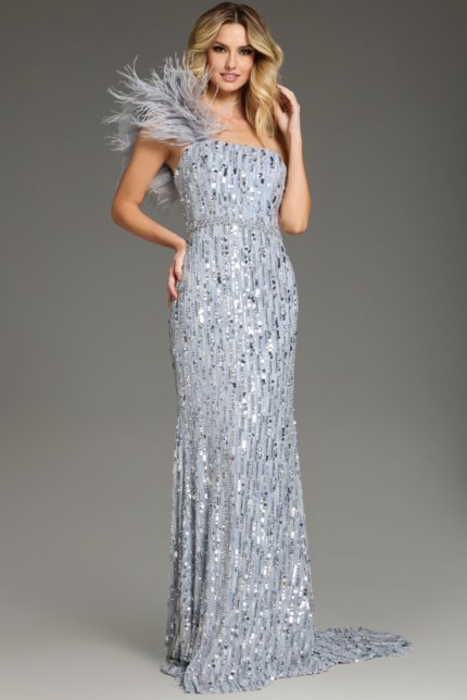 Model wearing Jovani 42426, a floor-length blue sequin gown with feathered shoulder.