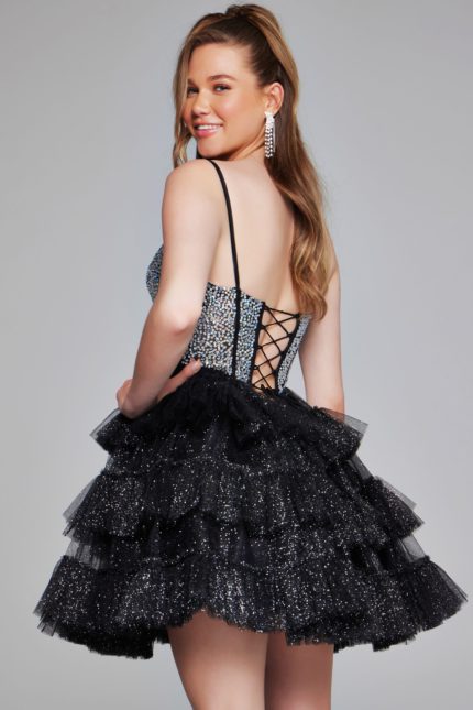 Model showing the back of Jovani 42457 black dress with lace-up design.