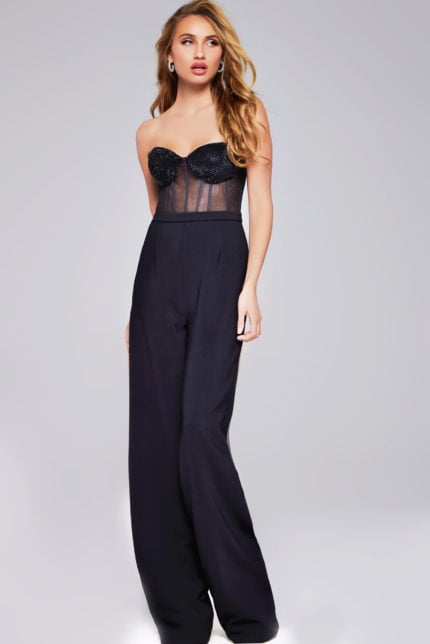 Model wearing Jovani 42466 black jumpsuit with a strapless neckline and beaded bodice, side view.