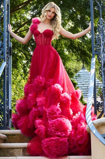 model showcasing Jovani 42781 red gown with asymmetric rosette shoulder