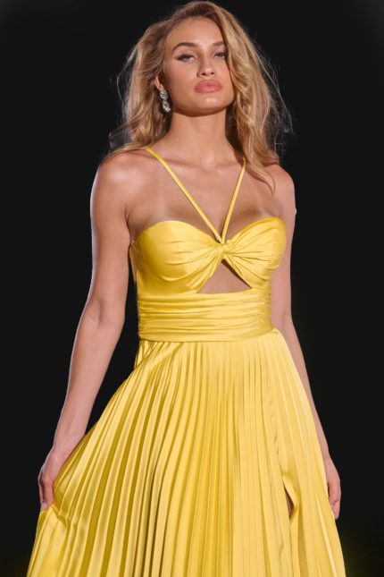 Model wearing Jovani 42971 yellow dress with pleated skirt, close-up front view.