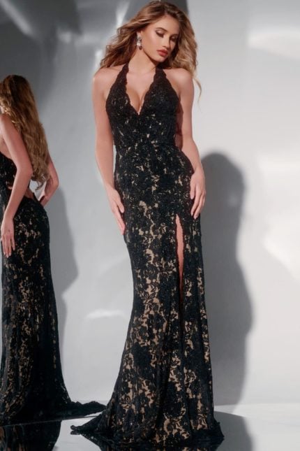 Model wearing Jovani 43097 black lace gown with halter neckline and high slit