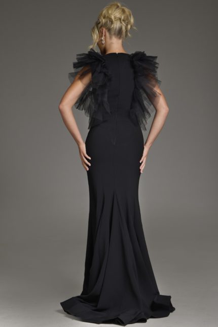 Model wearing Jovani 43153 black dress with flutter sleeves, back view.