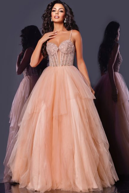 Model in Jovani 43254 blush gown featuring intricate embellishments and tulle layers