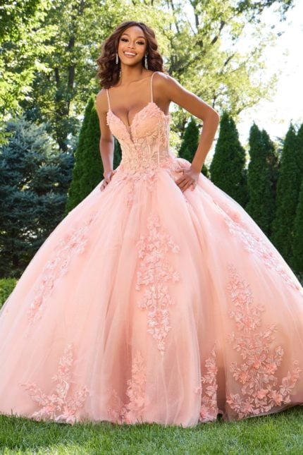 Model wearing Jovani 43431 blush gown with floral appliqués, front view.