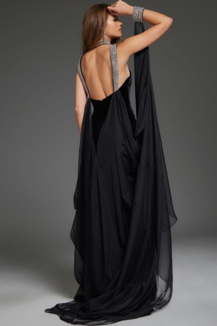 Back view of model wearing Jovani 43696 black gown showing elegant flowing fabric