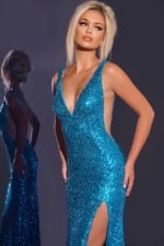 Model in Jovani 43725 blue sequin gown showing high slit and deep V-neckline.