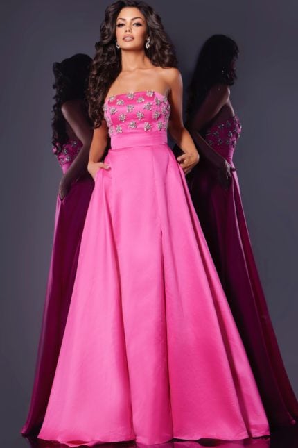 Model wearing Jovani 43822 pink evening gown with floral embellishments and high slit.