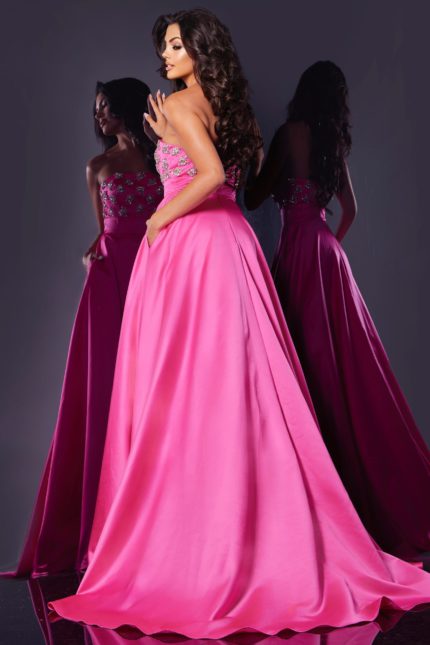 Back view of model in Jovani 43822 pink evening gown, showcasing train and floral details.