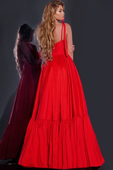 Model in Jovani 44182 back view of long red gown with flowing skirt