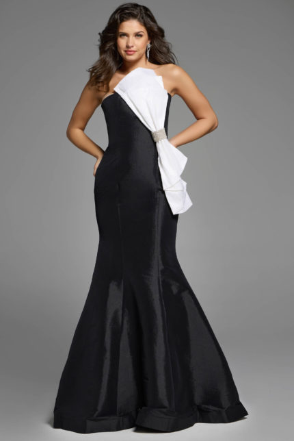 Strapless mermaid gown with asymmetrical white bow and rhinestone detail.