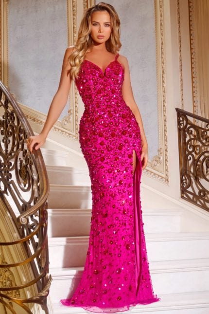 Model wearing Jovani 44440 fuchsia gown with embellishments and side slit, featuring a sweetheart neckline and open back.