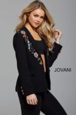 Model wearing Jovani M55213 black blazer with floral embellishments, angled front