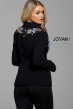 Model wearing Jovani M55213 black blazer with floral embellishments, back view