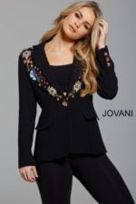 Model wearing Jovani M55213 black blazer with floral embellishments, front close-up