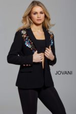 Model wearing Jovani M55213 black blazer with floral embellishments, front view