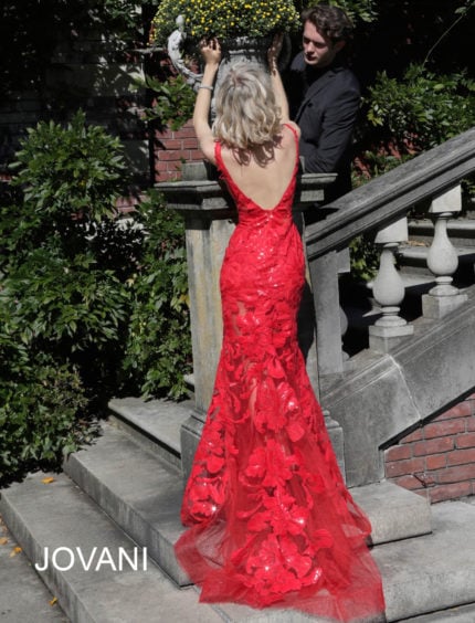 Back view of Jovani 60283 red mermaid gown showcasing intricate lace detailing.