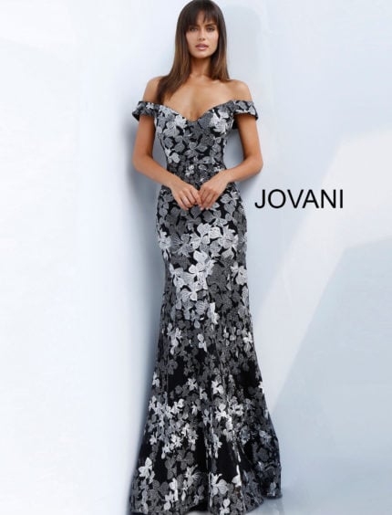 Model wearing Jovani 61380 black dress with off-shoulder neckline and floral embroidery, front view.