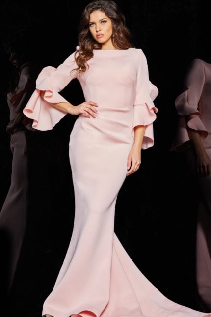 Model wearing Jovani 63168 blush dress with mermaid silhouette and tiered bell sleeves.