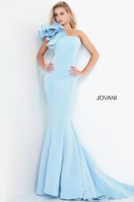 Model in Jovani 63994 light blue gown with one-shoulder ruffle detail.