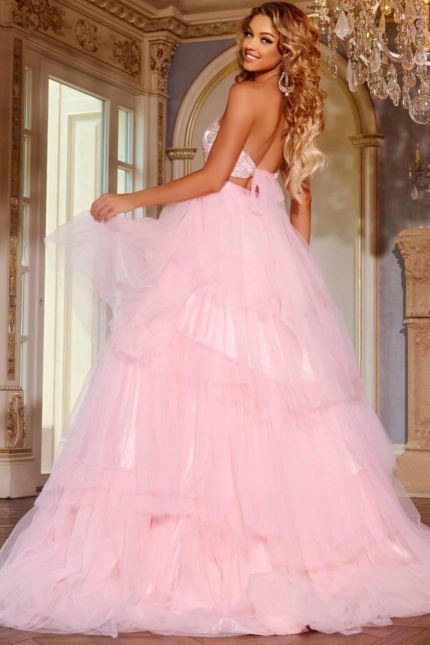 Model wearing D5112 pink ball gown with bow detail, back view.