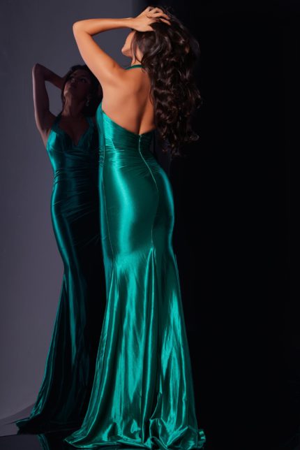 Back view of model wearing Jovani D5817 emerald gown with open back.