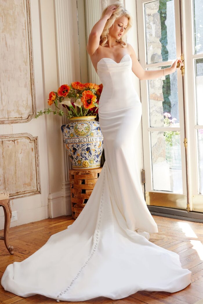 Model wearing Jovani Bridal JB04879 Off White Pleated Bust Sheath Strapless Wedding Gown