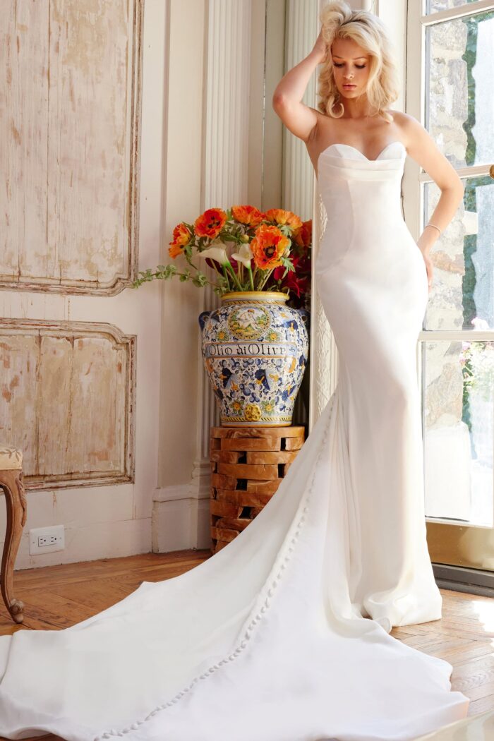 Model wearing Jovani Bridal JB04879 Off White Pleated Bust Sheath Strapless Wedding Gown