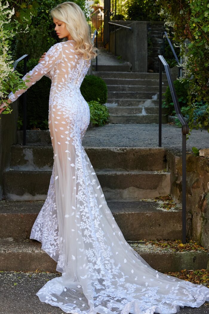 Model wearing Jovani JB06861 Ivory Embellished Long Sleeve Illusion Wedding Dress