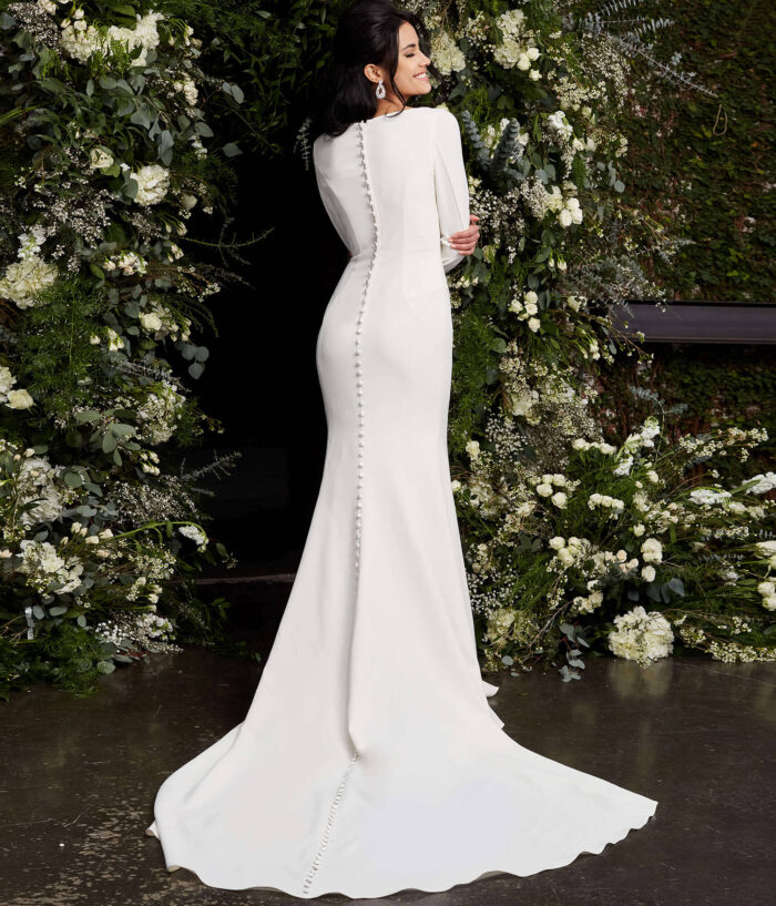 Model wearing Jovani JB06911 Ivory Plunging Neck Long Sleeve Wedding Dress
