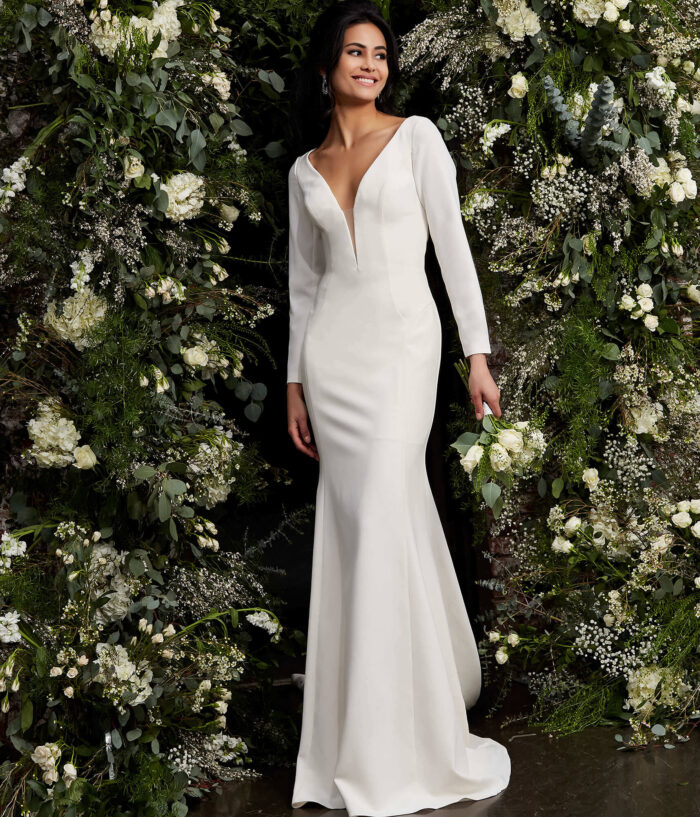 Model wearing Jovani JB06911 Ivory Plunging Neck Long Sleeve Wedding Dress