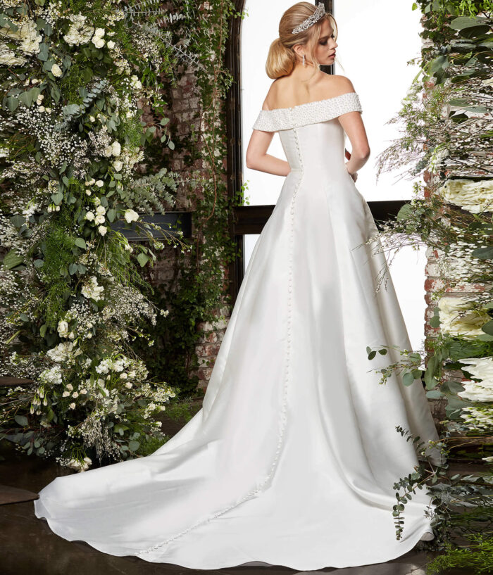 Model wearing Jovani JB07134 Ivory Off the Shoulder A Line Bridal Dress