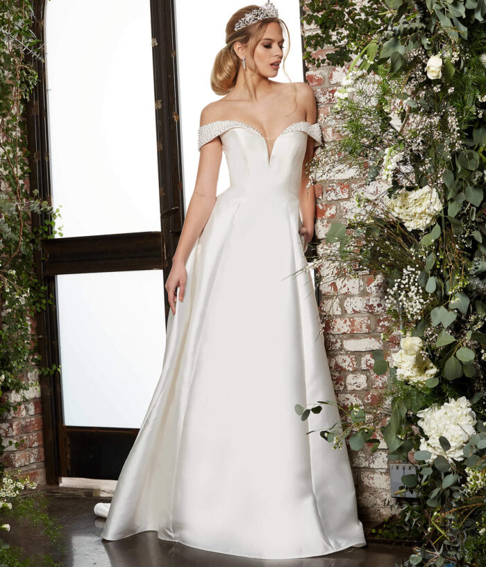 Model wearing Jovani JB07134 Ivory Off the Shoulder A Line Bridal Dress