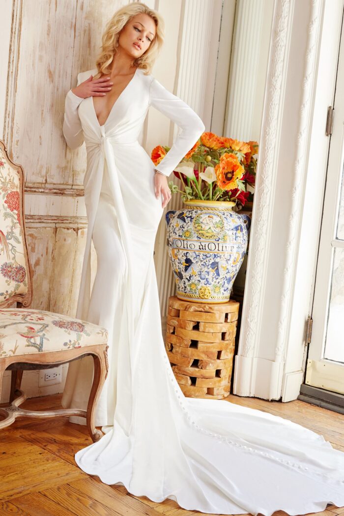 Model wearing Jovani Bridal JB23181 Off White Long Sleeve Plunging Neck Wedding Dress