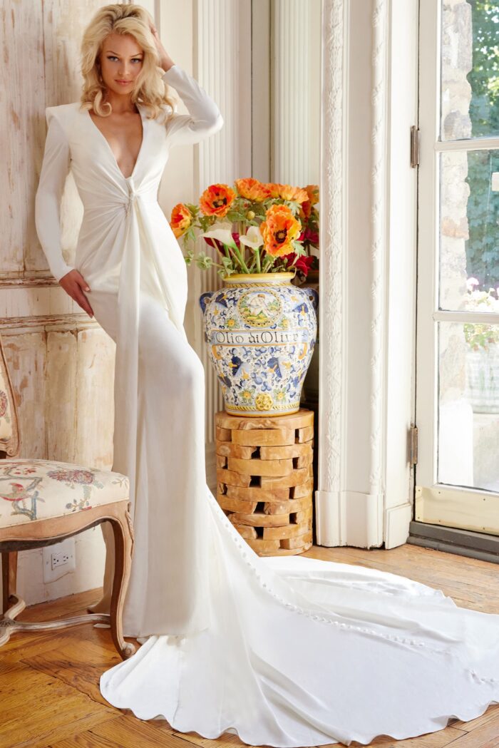 Model wearing Jovani Bridal JB23181 Off White Long Sleeve Plunging Neck Wedding Dress