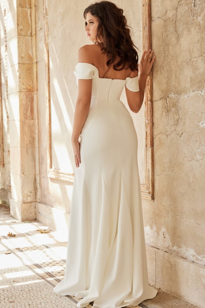Model wearing Off the Shoulder White Sheath Dress with Bow Detail and High Slit JB36882