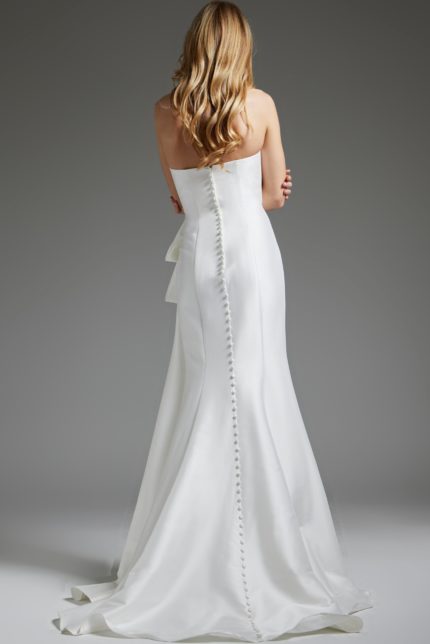 Back view of model in Jovani JB40791 white gown with button detail.