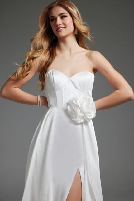 model wearing Jovani JB40825 white gown showing a floral waist embellishment