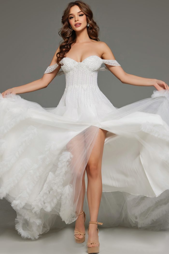 Model twirling in a beaded corset bridal dress with high slit