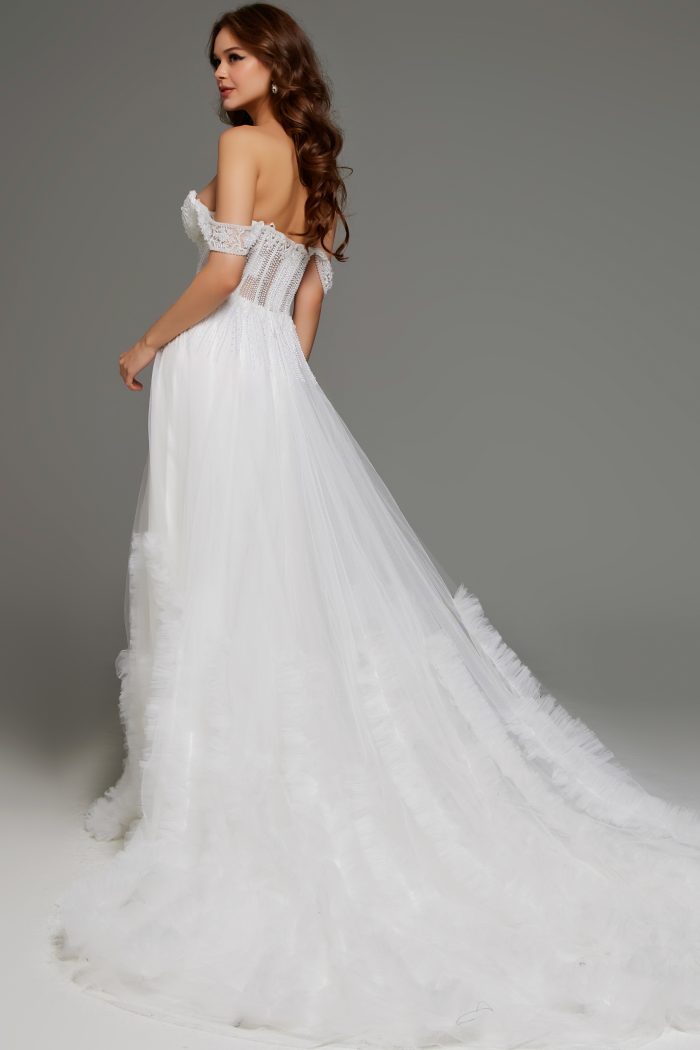 Back view of an off-shoulder bridal gown with flowing tulle skirt