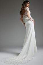 Model wearing Jovani JB42297 ivory gown from the back, showcasing lace details and train.