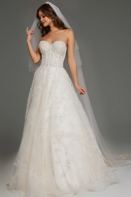 Model wearing JB42766 elegant white gown with floral lace detailing and strapless neckline.