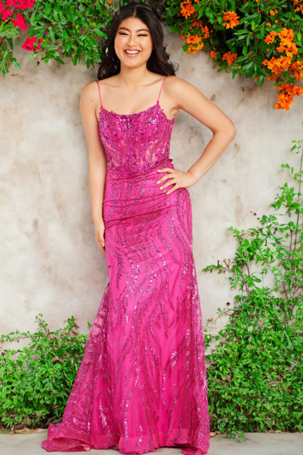 Model wearing Jovani 23250 fuchsia gown with sequined design and lace-up back.