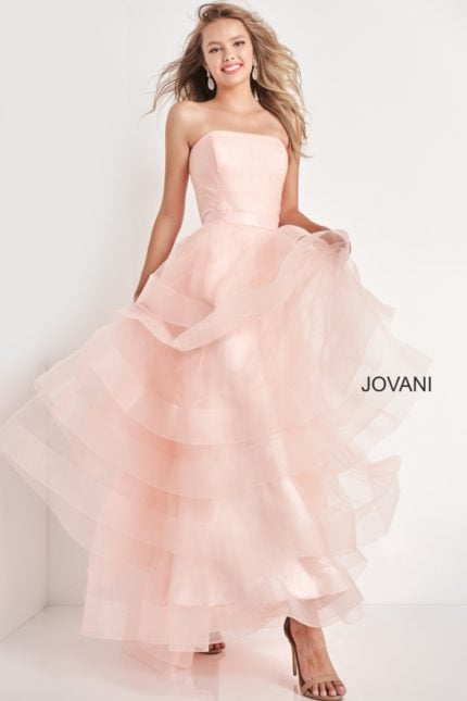 Model wearing Jovani K02442 pink dress with layered tulle skirt, front view.