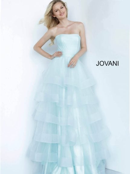 Model wearing Jovani K02442 blue dress with layered tulle skirt, front view.