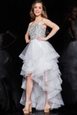 Model in Jovani K05916, showcasing a white strapless sequin dress with a tulle skirt, front view.