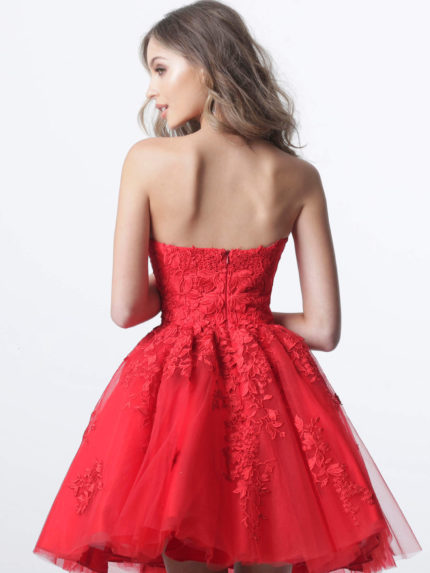 Model wearing K1830 dress in red with floral lace appliqués, back view