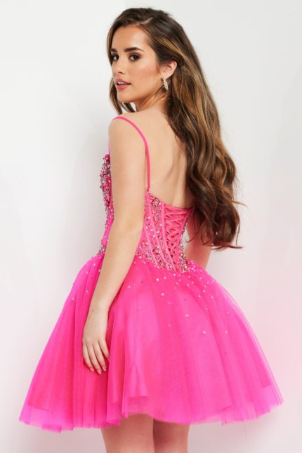 Model wearing Jovani K62533 fuchsia dress showing the back lace-up design.