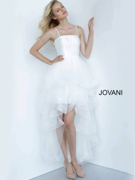 Model wearing Jovani K66708 white dress with layered ruffle skirt and square neckline from the front.